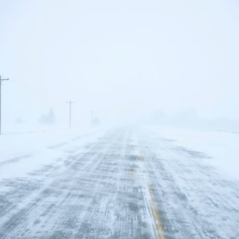 Snow blows and drifts over County Road K22 near Merrill, Iowa, on Friday, Jan. 12, 2024. (AP Photo/Carolyn Kaster)