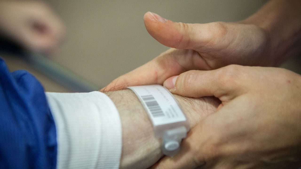 Outpatient surgery, Leon Berard Centre, Lyon, France, This cancer center takes patients to theater standing up, an innovative way of welcoming patients to the operating theater, patients are taken to theater on foot, A patient is treated for dysphagia as a result of stomach cancer. A nurse checks his identity. (Photo by: BSIP/UIG via Getty Images)