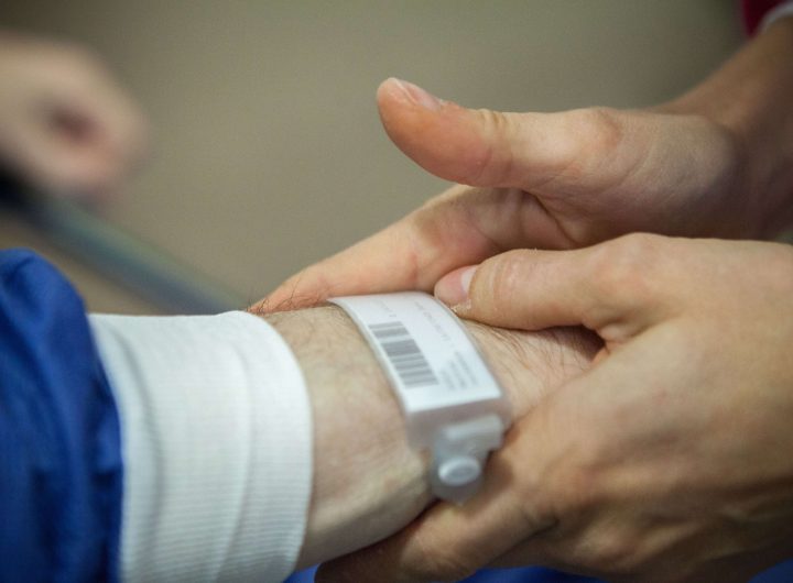 Outpatient surgery, Leon Berard Centre, Lyon, France, This cancer center takes patients to theater standing up, an innovative way of welcoming patients to the operating theater, patients are taken to theater on foot, A patient is treated for dysphagia as a result of stomach cancer. A nurse checks his identity. (Photo by: BSIP/UIG via Getty Images)